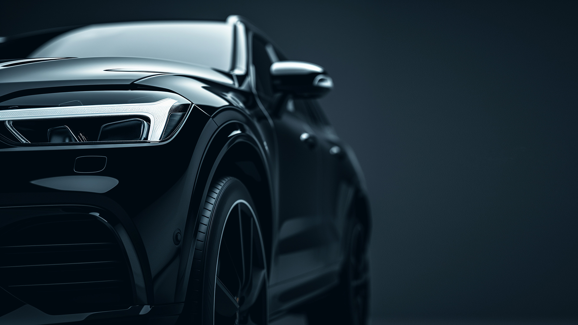 Front angle of a black SUV with LED headlights on a dark background.